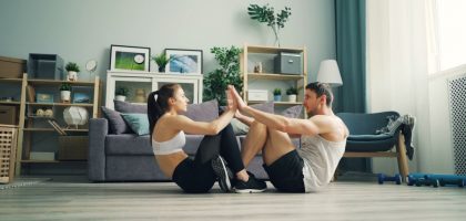 a man and woman sitting on the floor in a living room