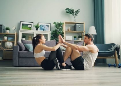 a man and woman sitting on the floor in a living room